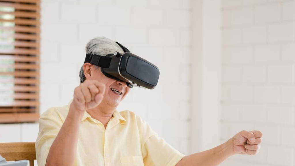 Asian elderly couple using tablet and virtual reality simulator
