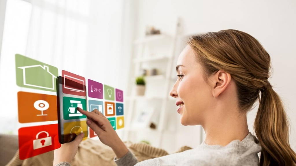 woman with tablet computer and smart home icons