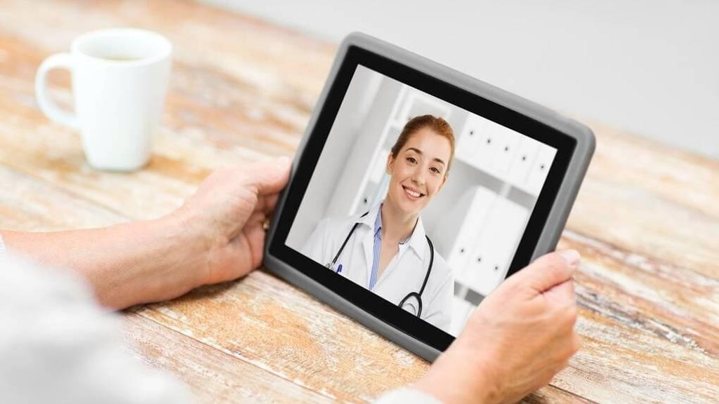 senior woman patient having video call with doctor