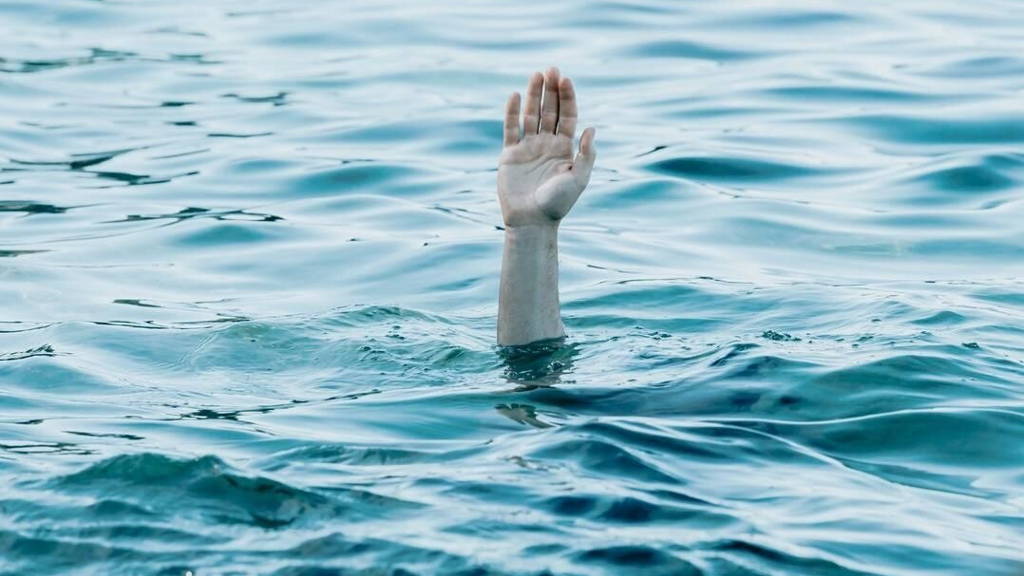 A hand showing out the ocean, rescue and help concept, self care, drown anxiety and problems conceptual image, copy space