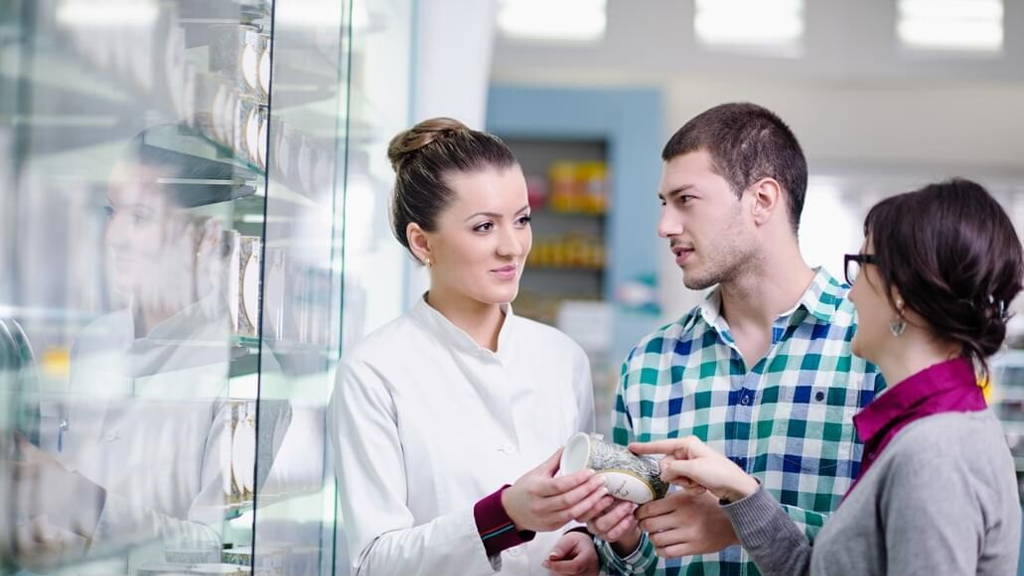 pharmacist suggesting medical drug to buyer in pharmacy drugstor