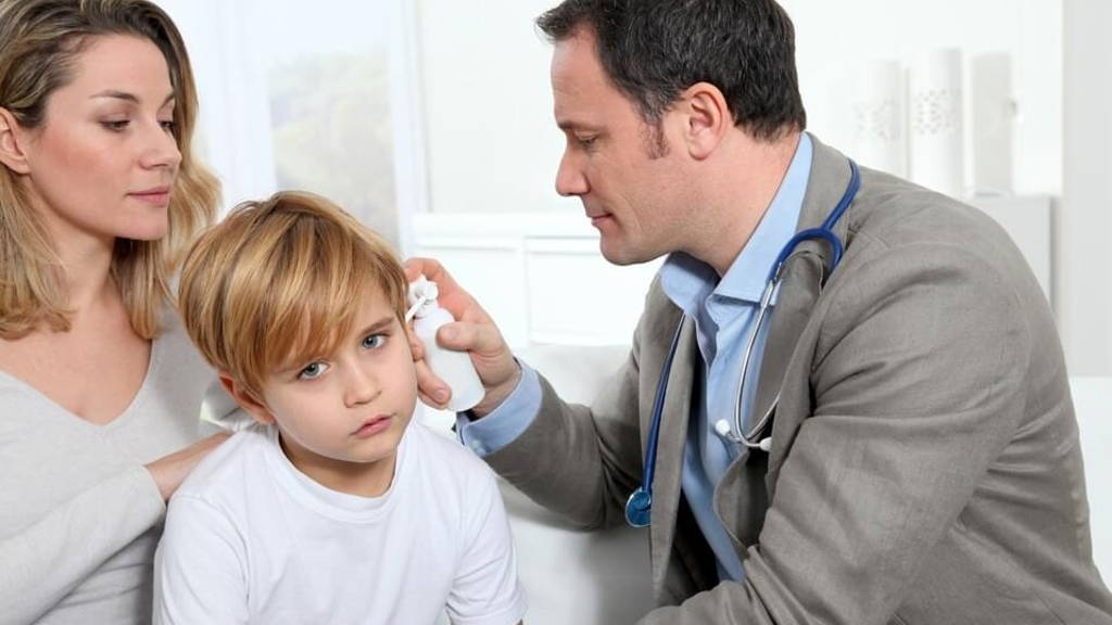 Doctor cheking little boy's ear infection