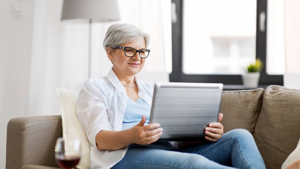 senior woman with on laptop resting at home