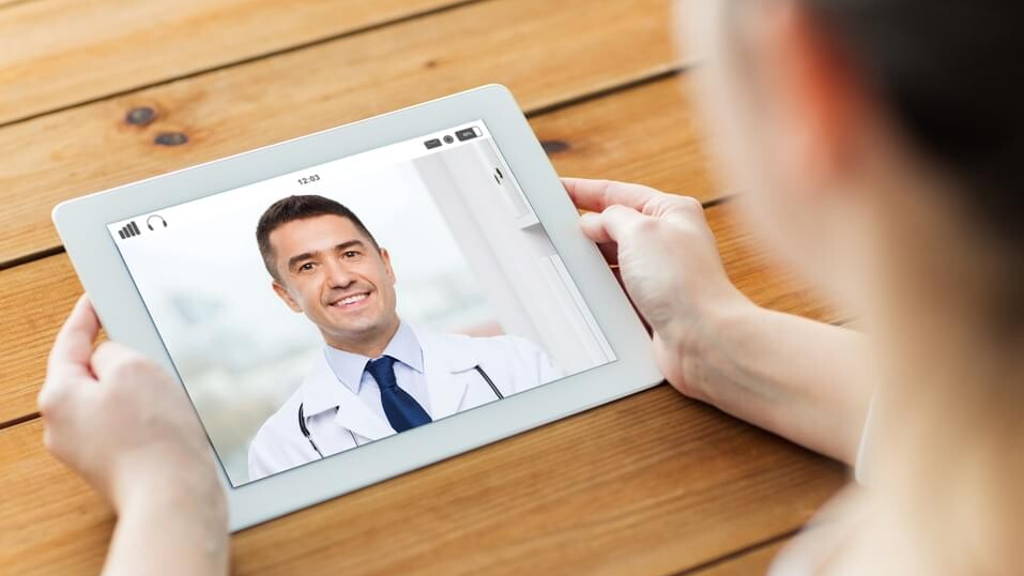 patient having video chat with doctor on tablet pc