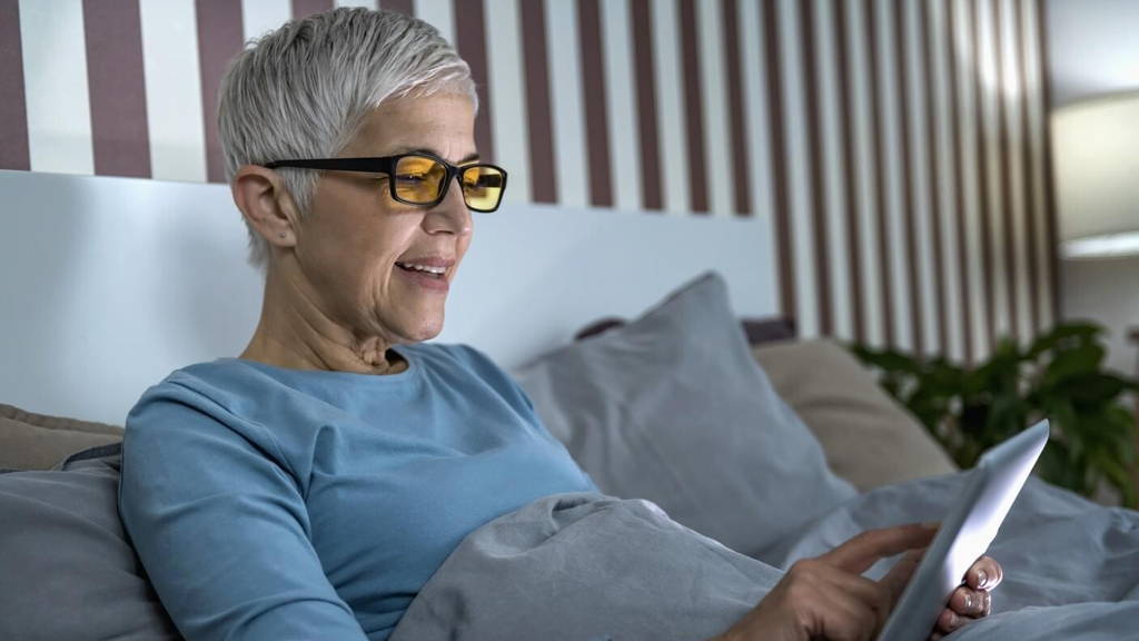 Mature Woman Wearing Blue Light Blocking Eye Glasses, Using Tablet