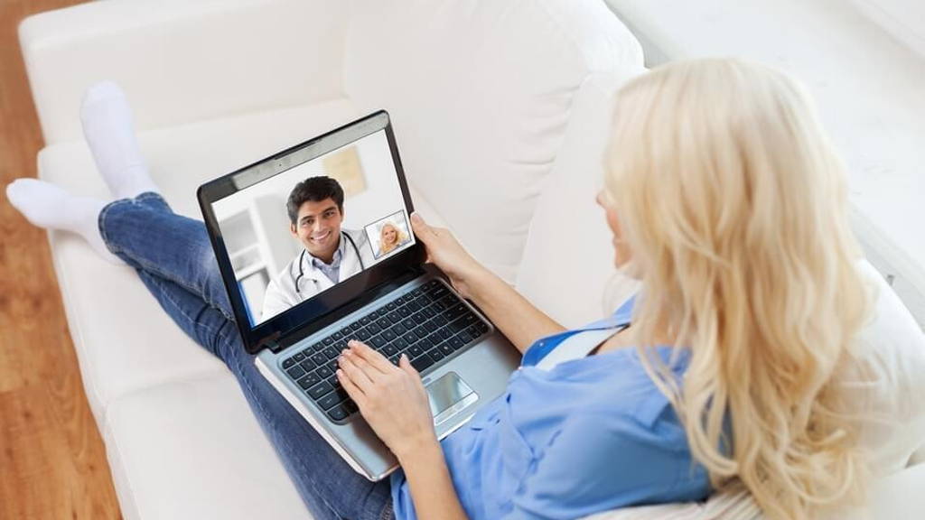 patient having video call with doctor on laptop