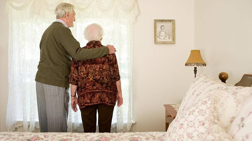 Elderly couple in their bedroom