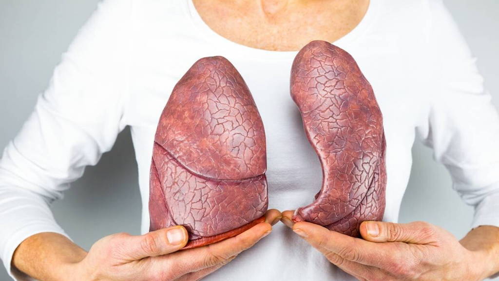 Woman showing two lungs in front of chest