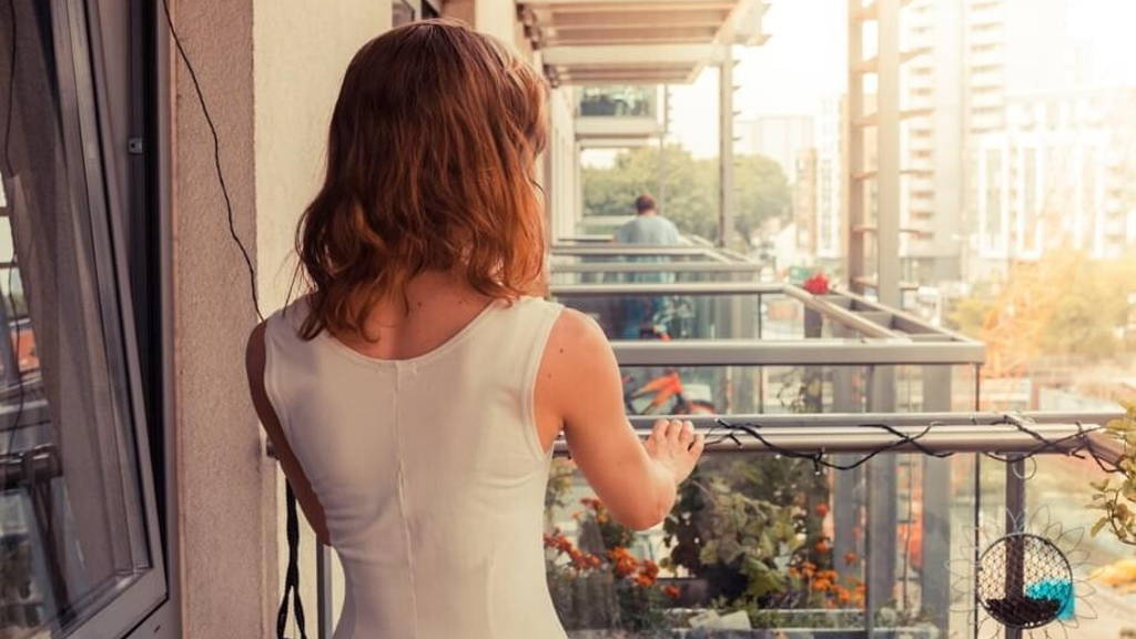 Young woman relaxing on her balcony